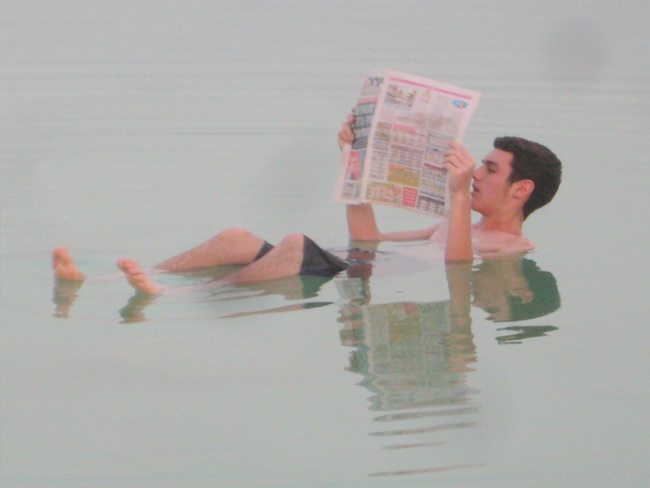 Catching up on the news while floating on the Dead Sea